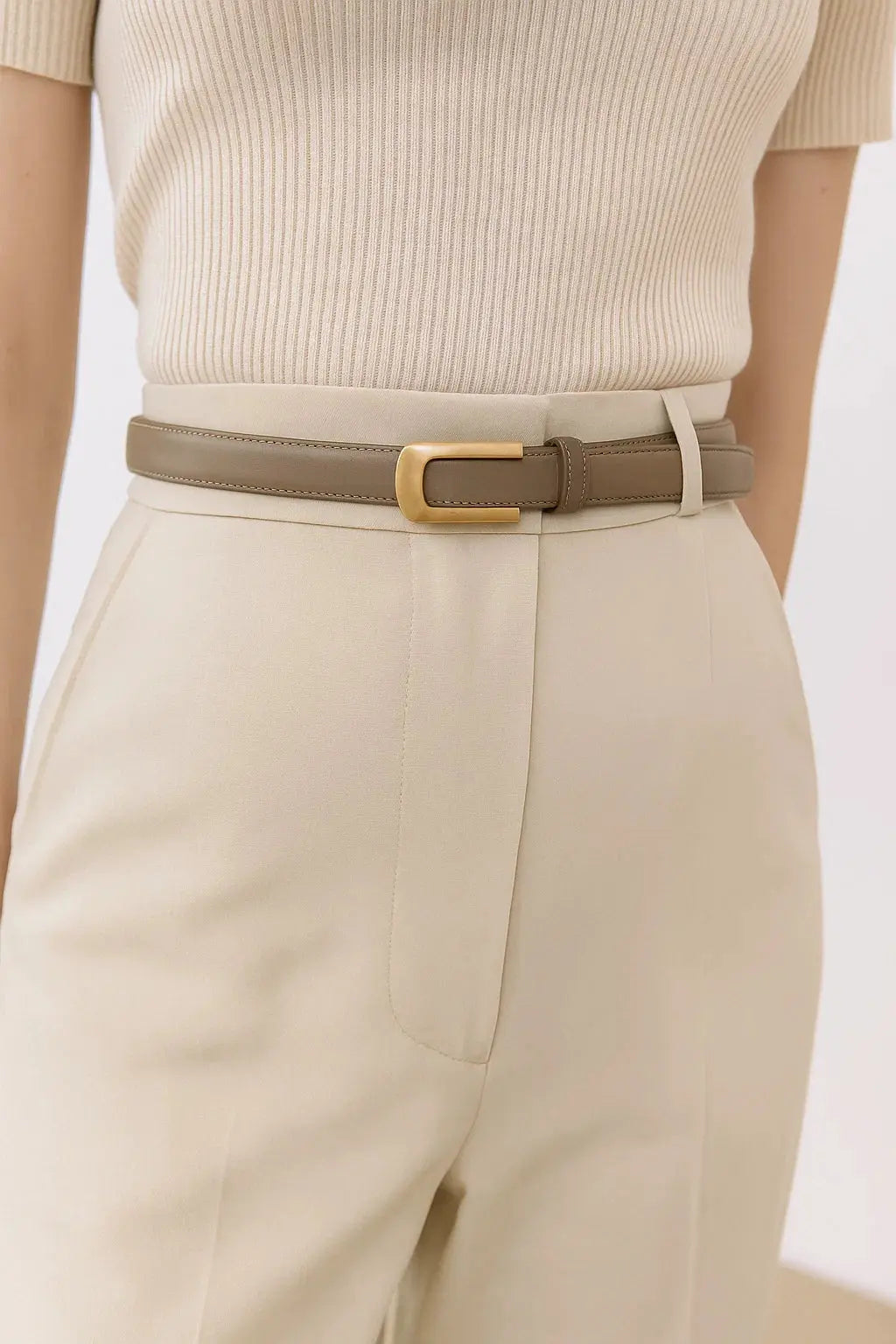 Grey belt worn by women on beige pants